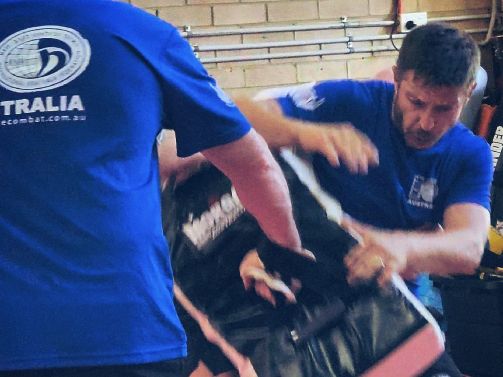Adults Krav Maga: members striking a kick shield during a drill at Close Combat